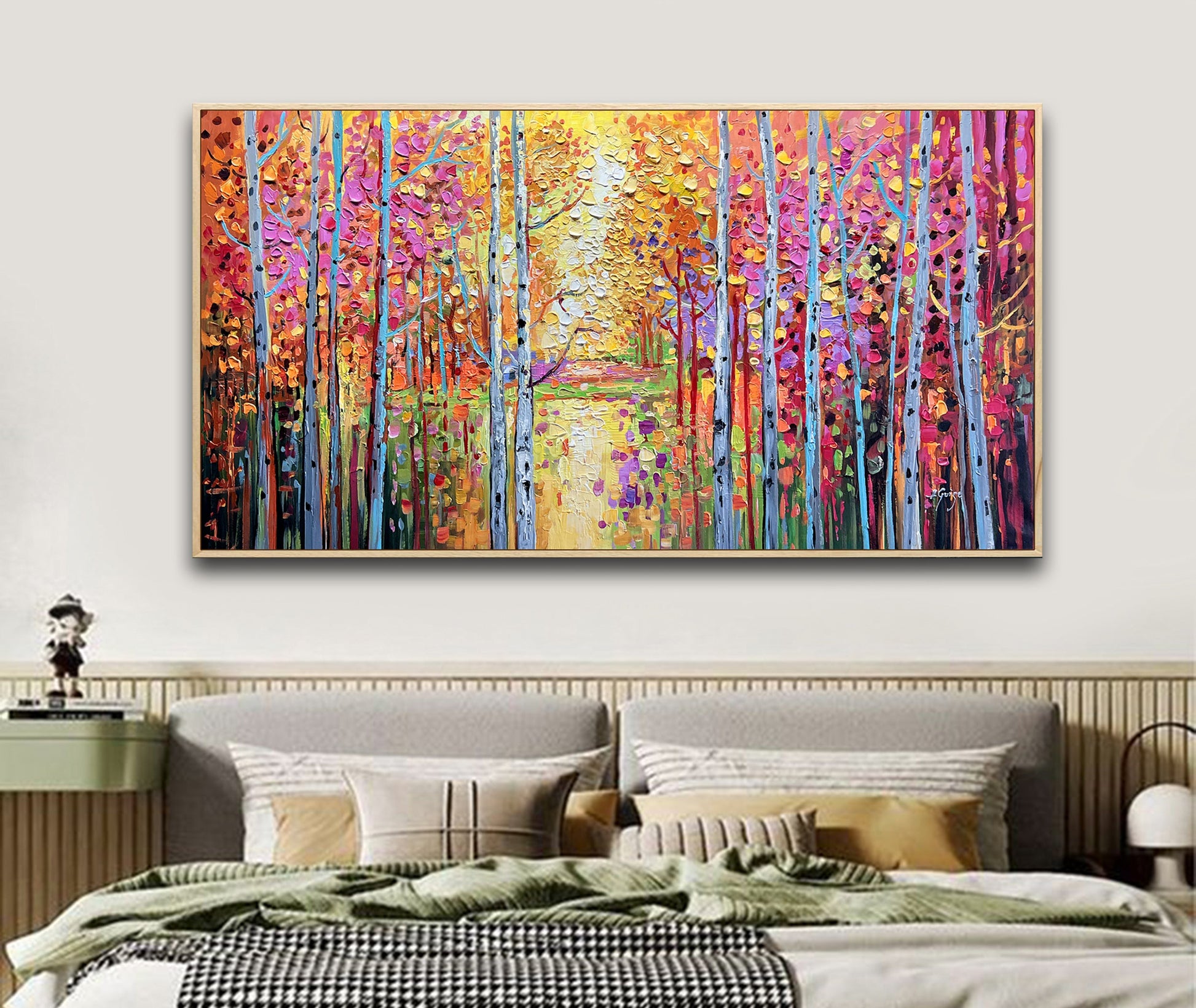 a bedroom with a bed and a painting on the wall