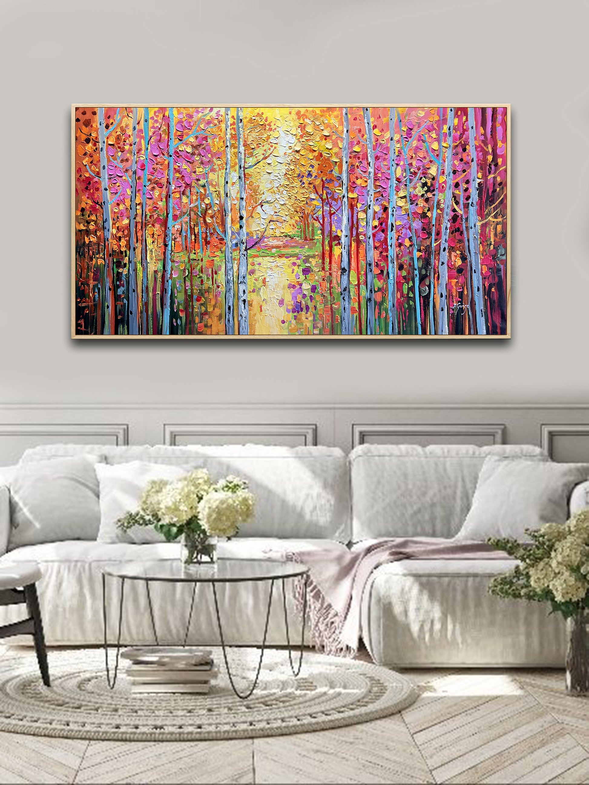 a living room with a large painting on the wall