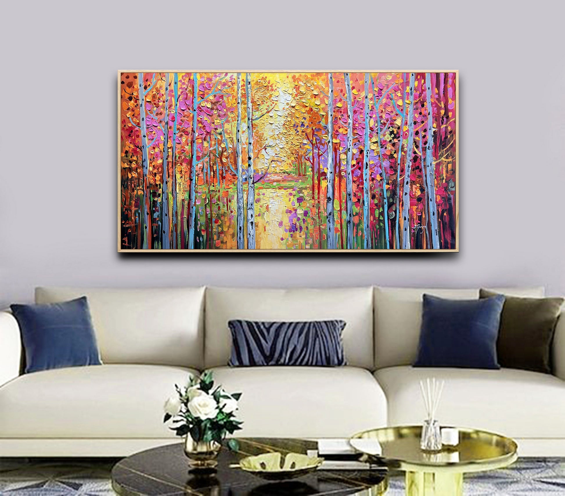 a living room with a couch and a painting on the wall