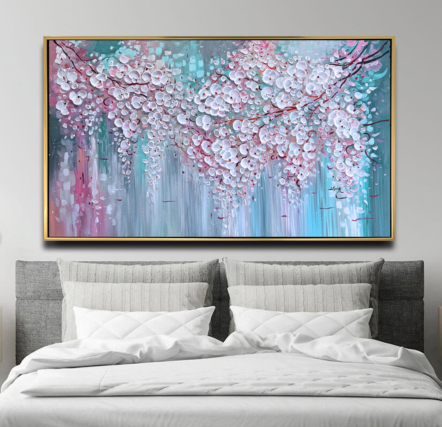 a bed with a white comforter and a painting on the wall