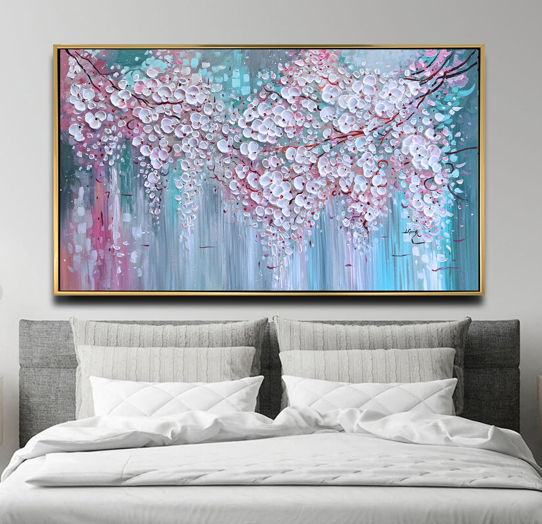 a bed with a white comforter and a painting on the wall