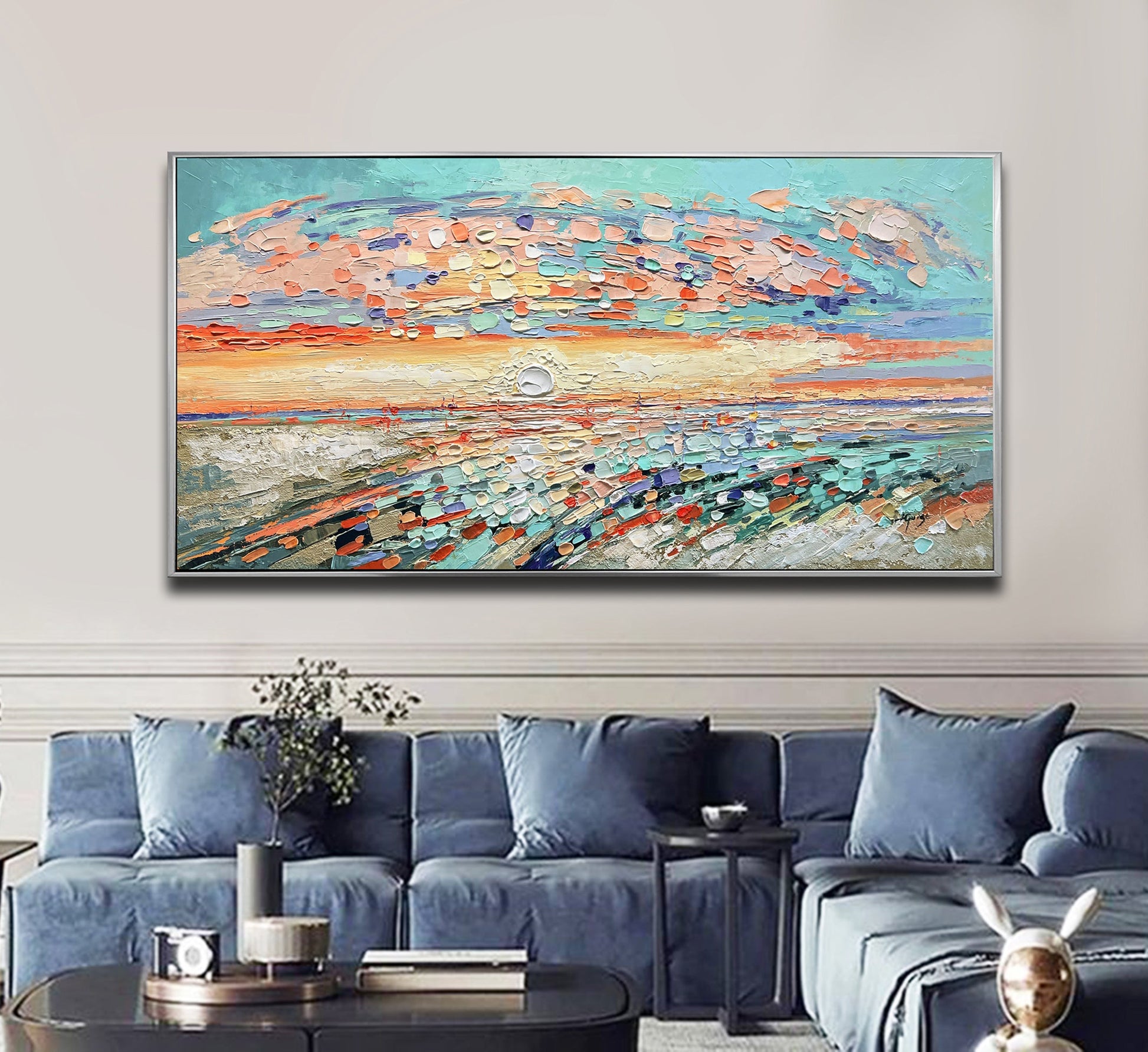 a living room with blue couches and a painting on the wall