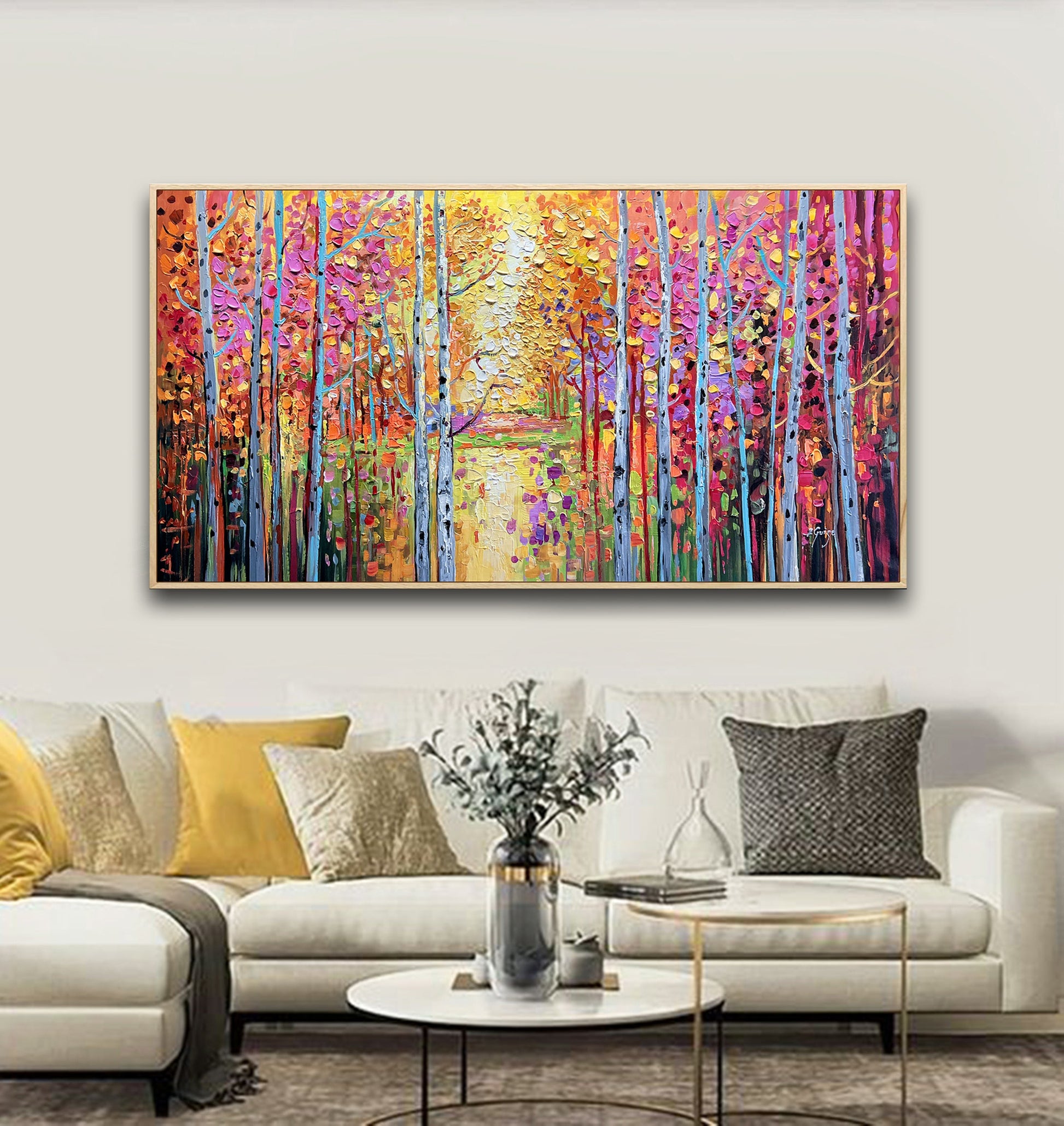 a living room with a couch and a painting on the wall