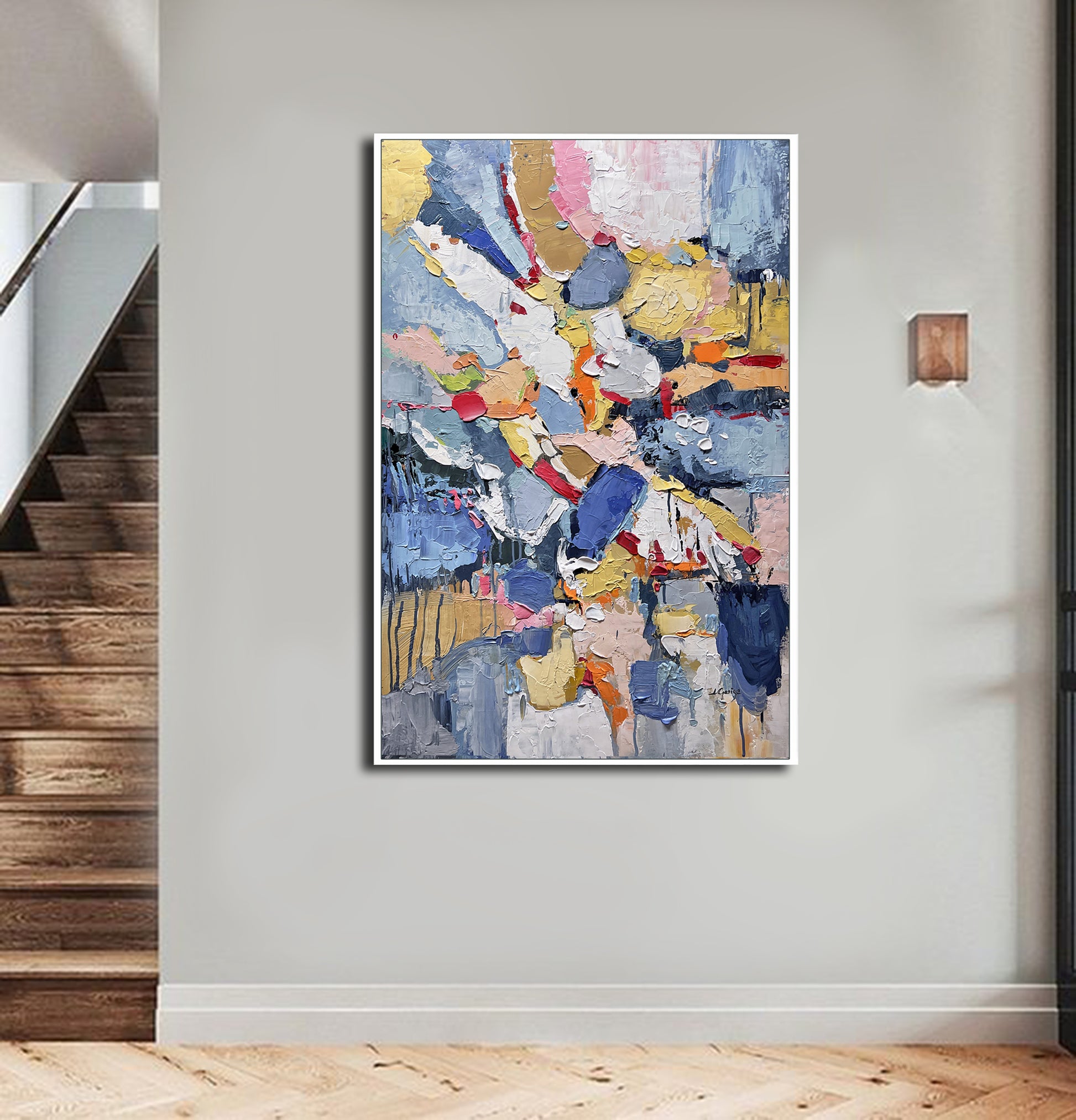 a painting hanging on a wall next to a stair case