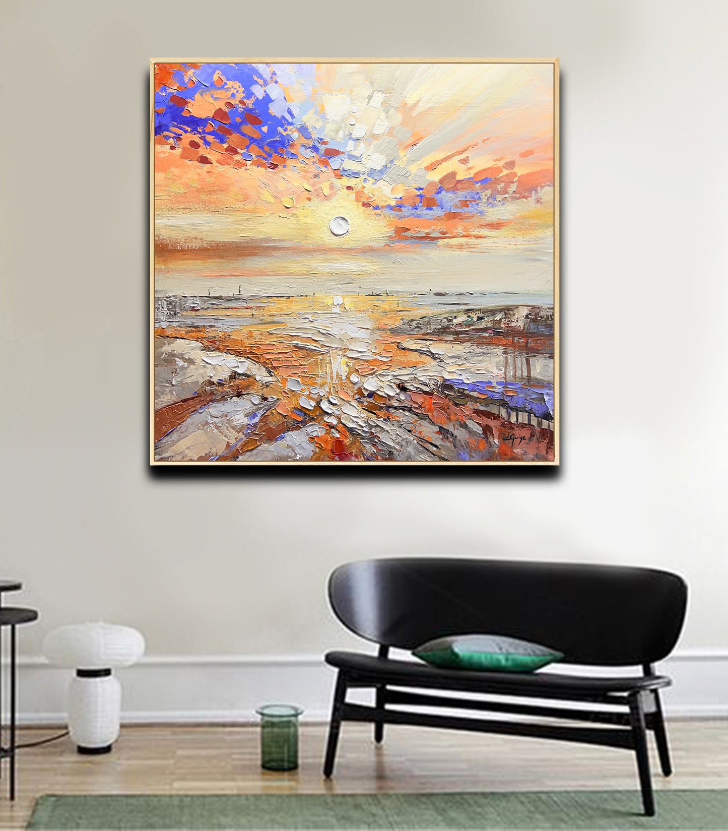 a living room with a couch and a painting on the wall