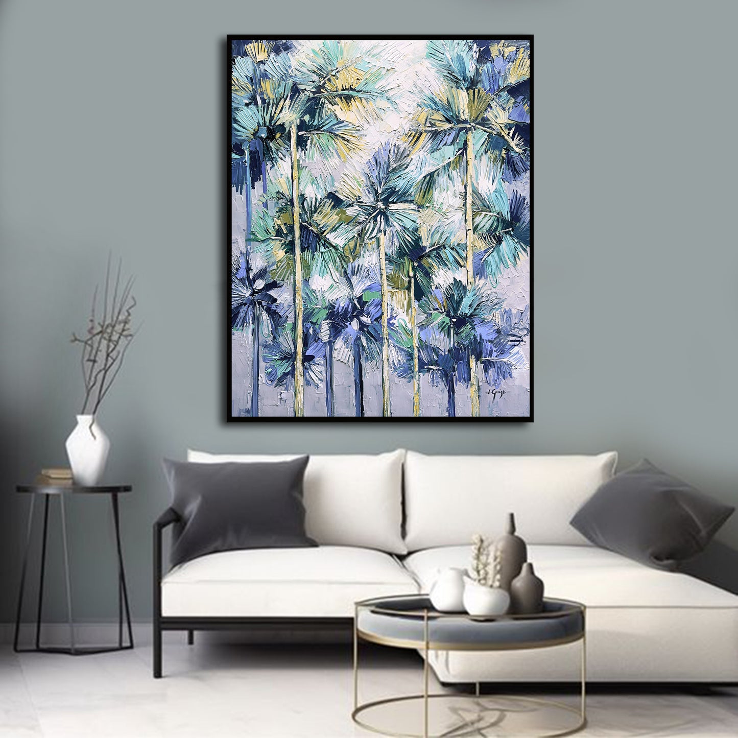 a living room with a white couch and a painting on the wall