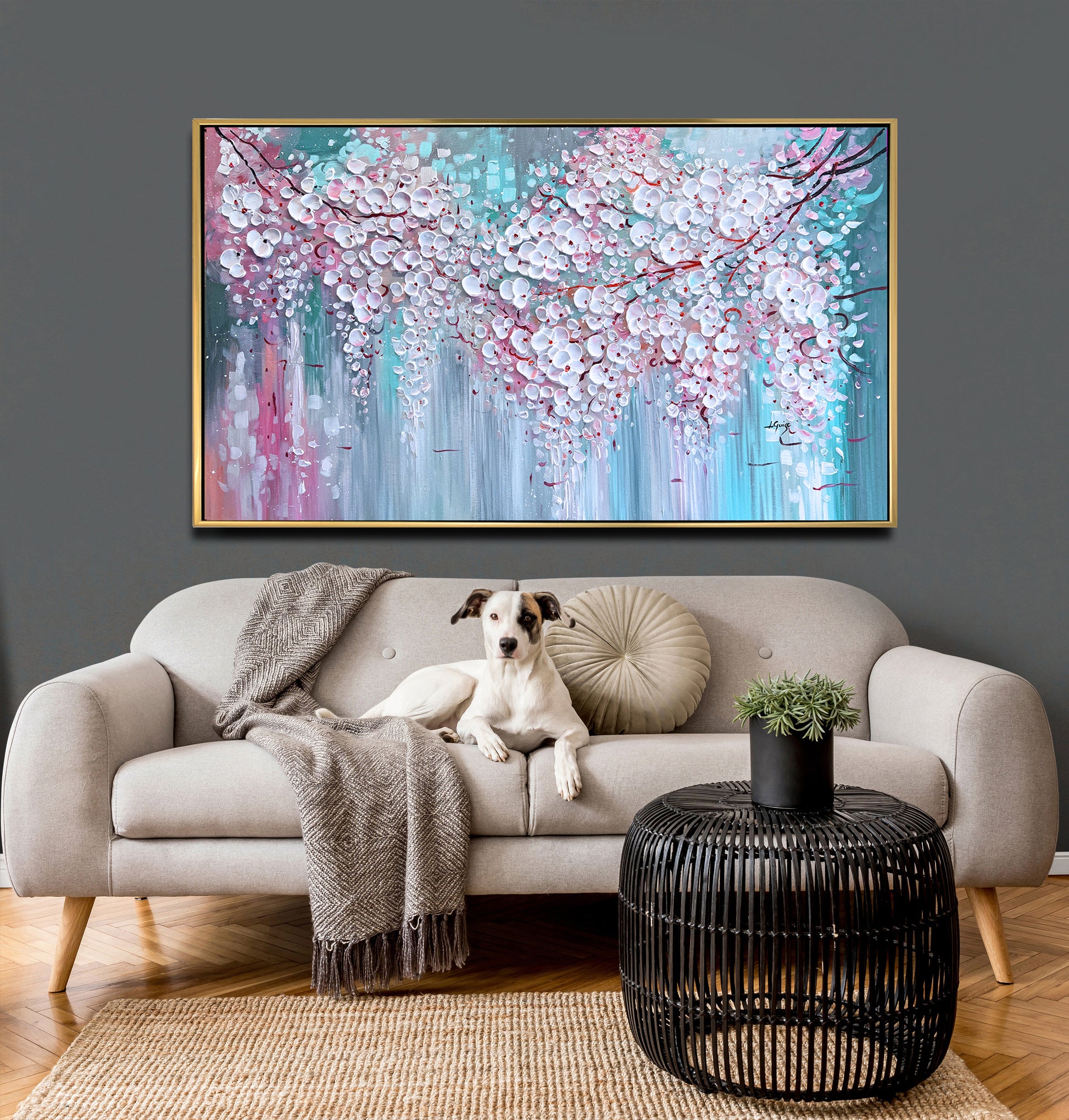 a dog sitting on a couch in front of a painting