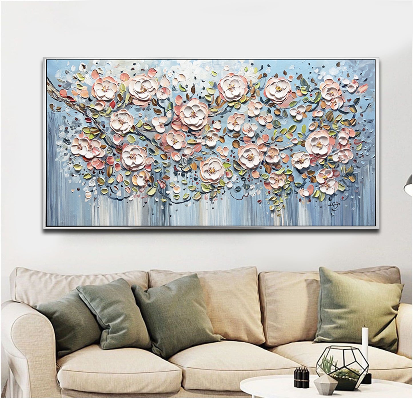 a living room with a couch and a painting on the wall