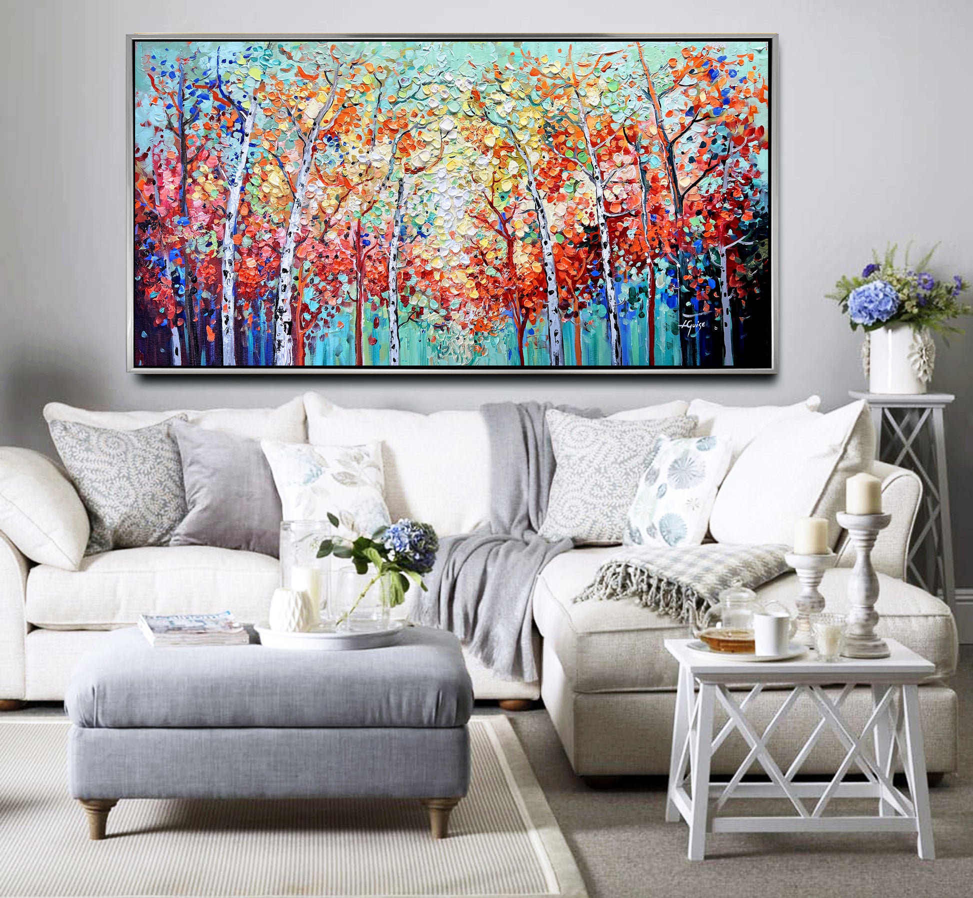 a living room filled with furniture and a painting on the wall