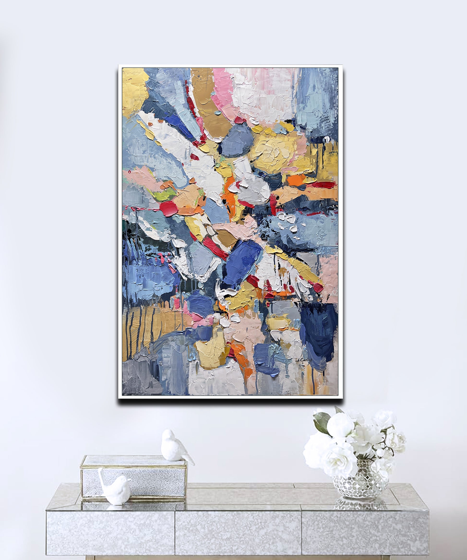 a painting hanging on a wall above a table