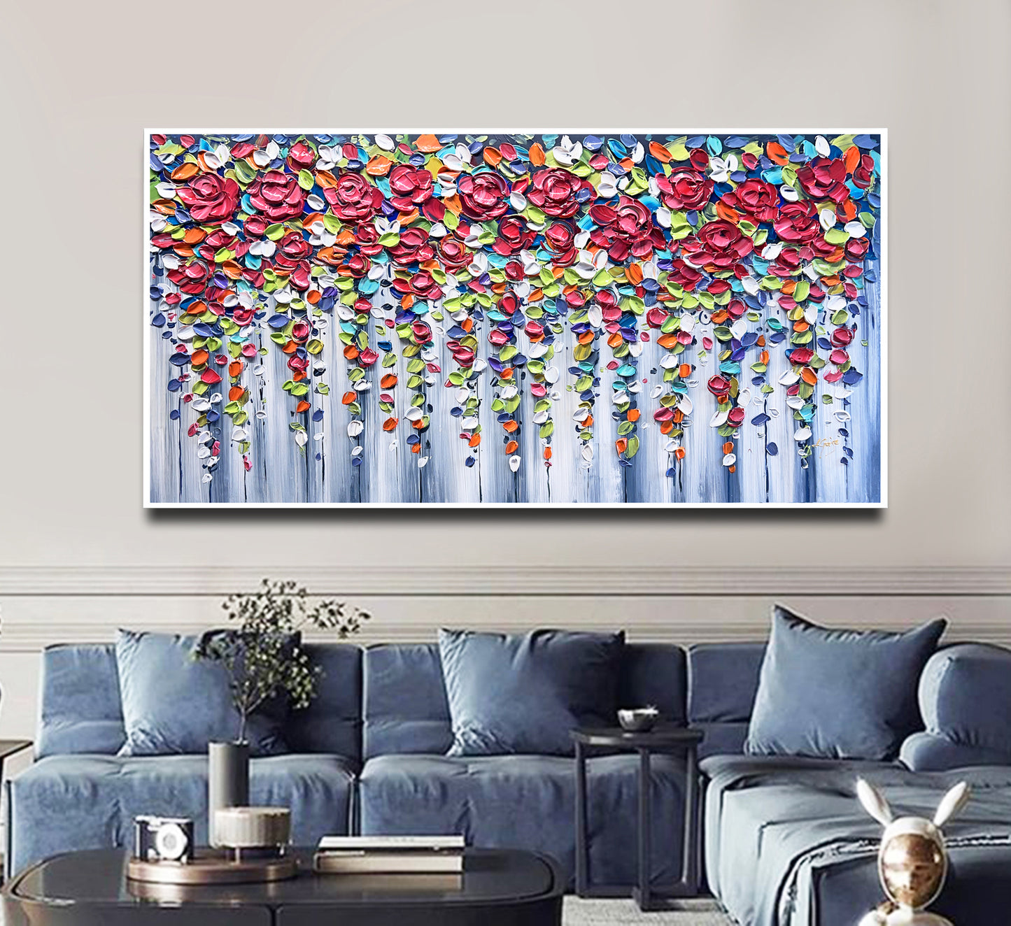 a living room with a blue couch and a painting on the wall