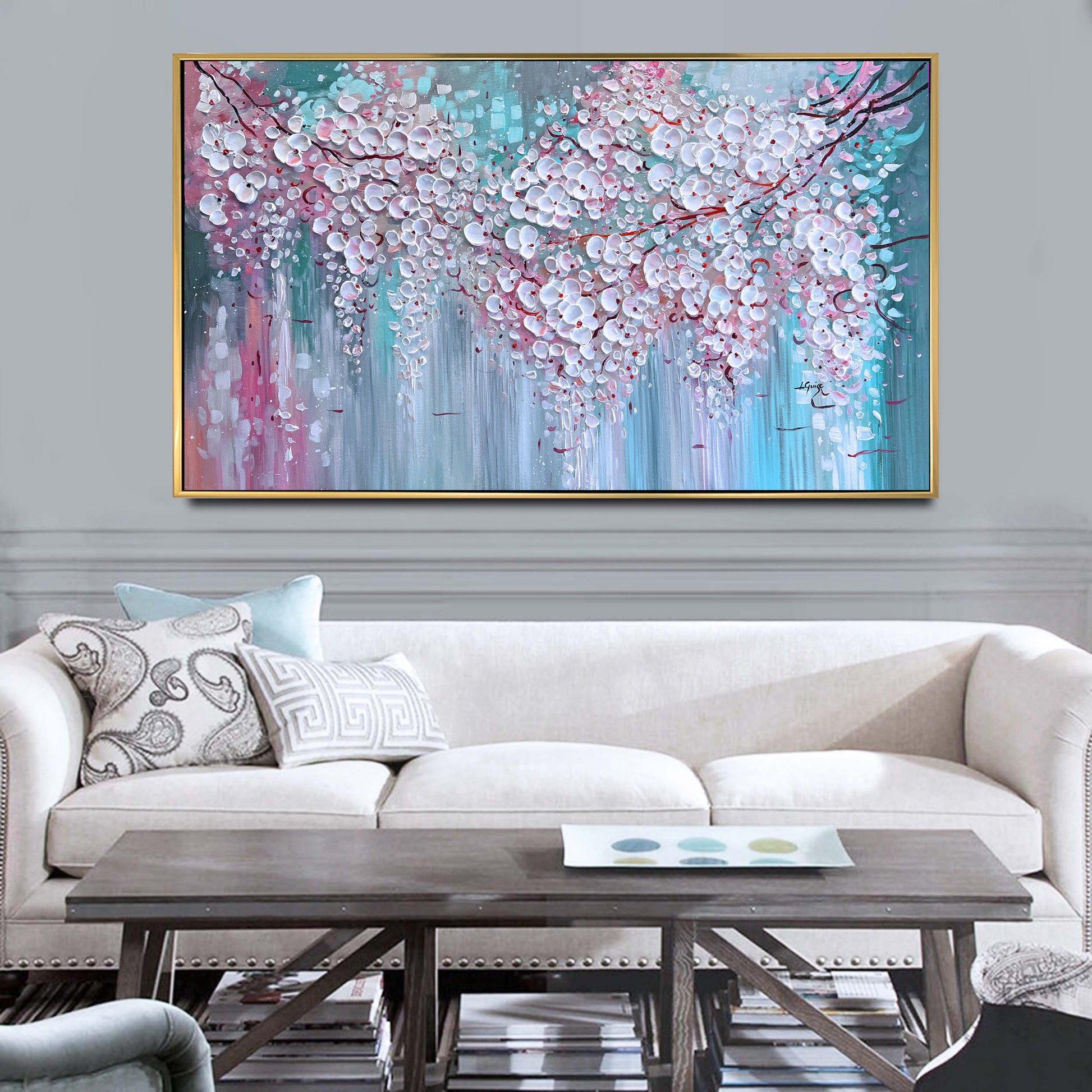 a living room with a couch and a painting on the wall