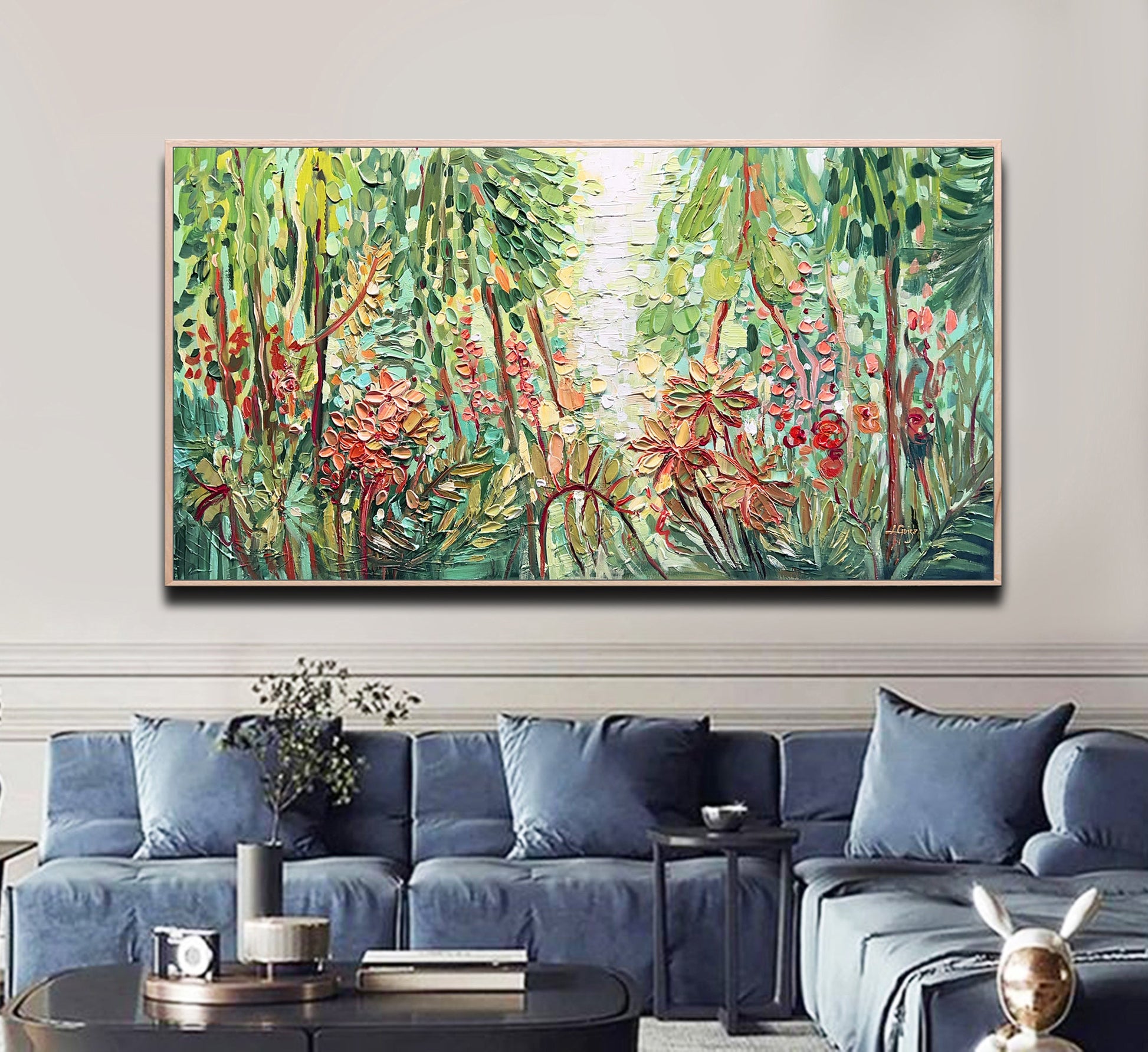 a living room with a blue couch and a painting on the wall