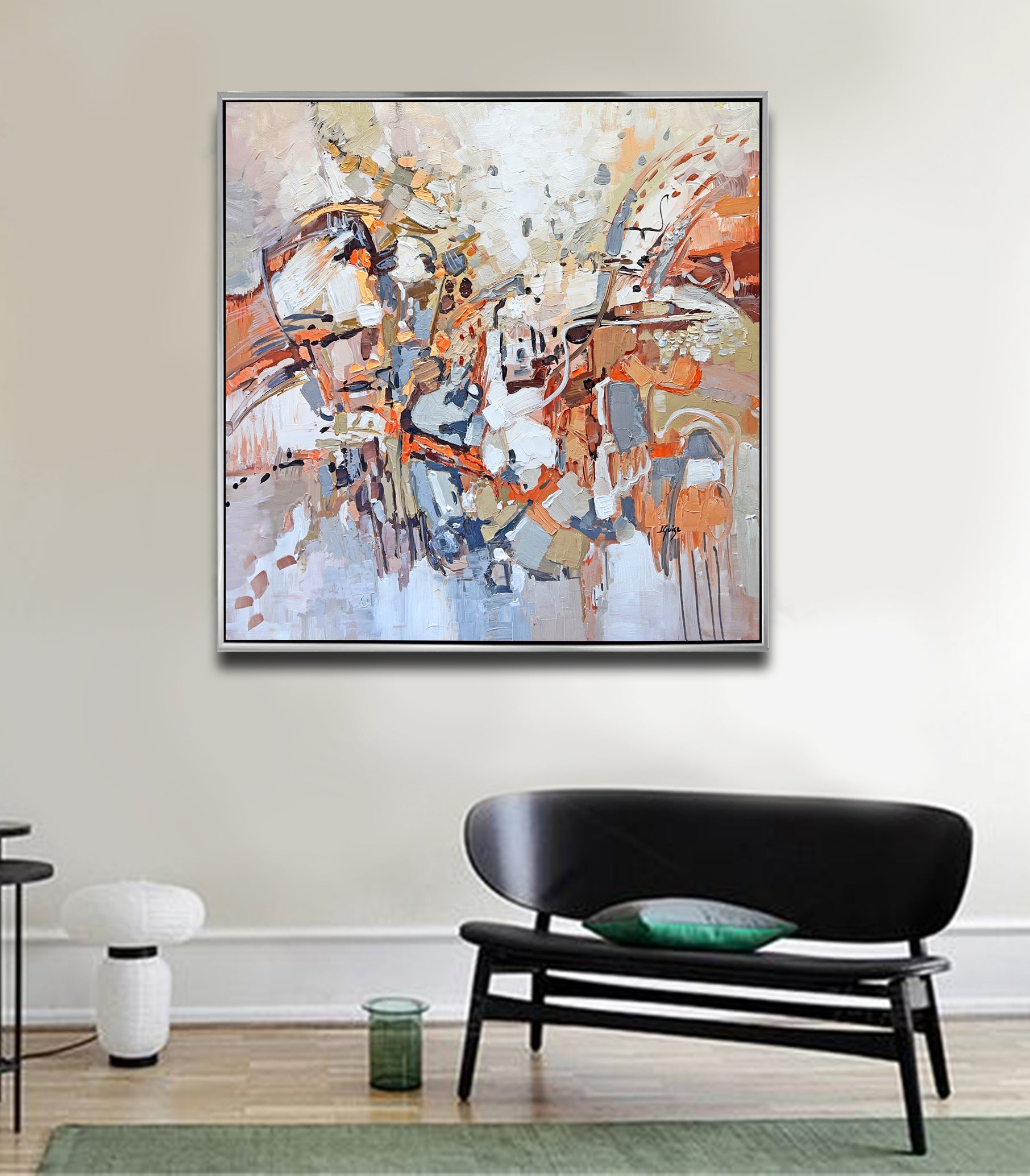 a living room with a couch and a painting on the wall