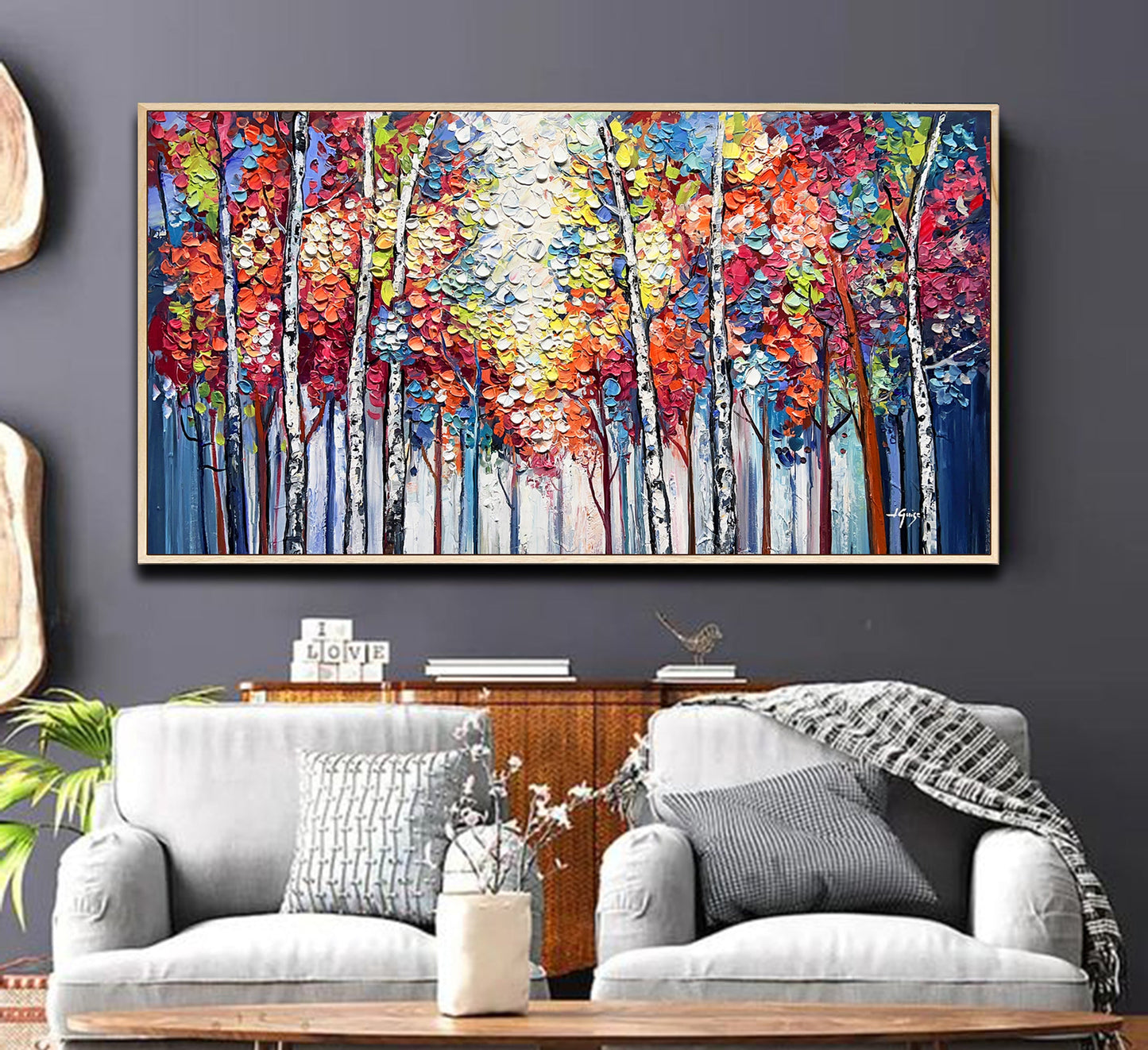a living room with a couch and a painting on the wall
