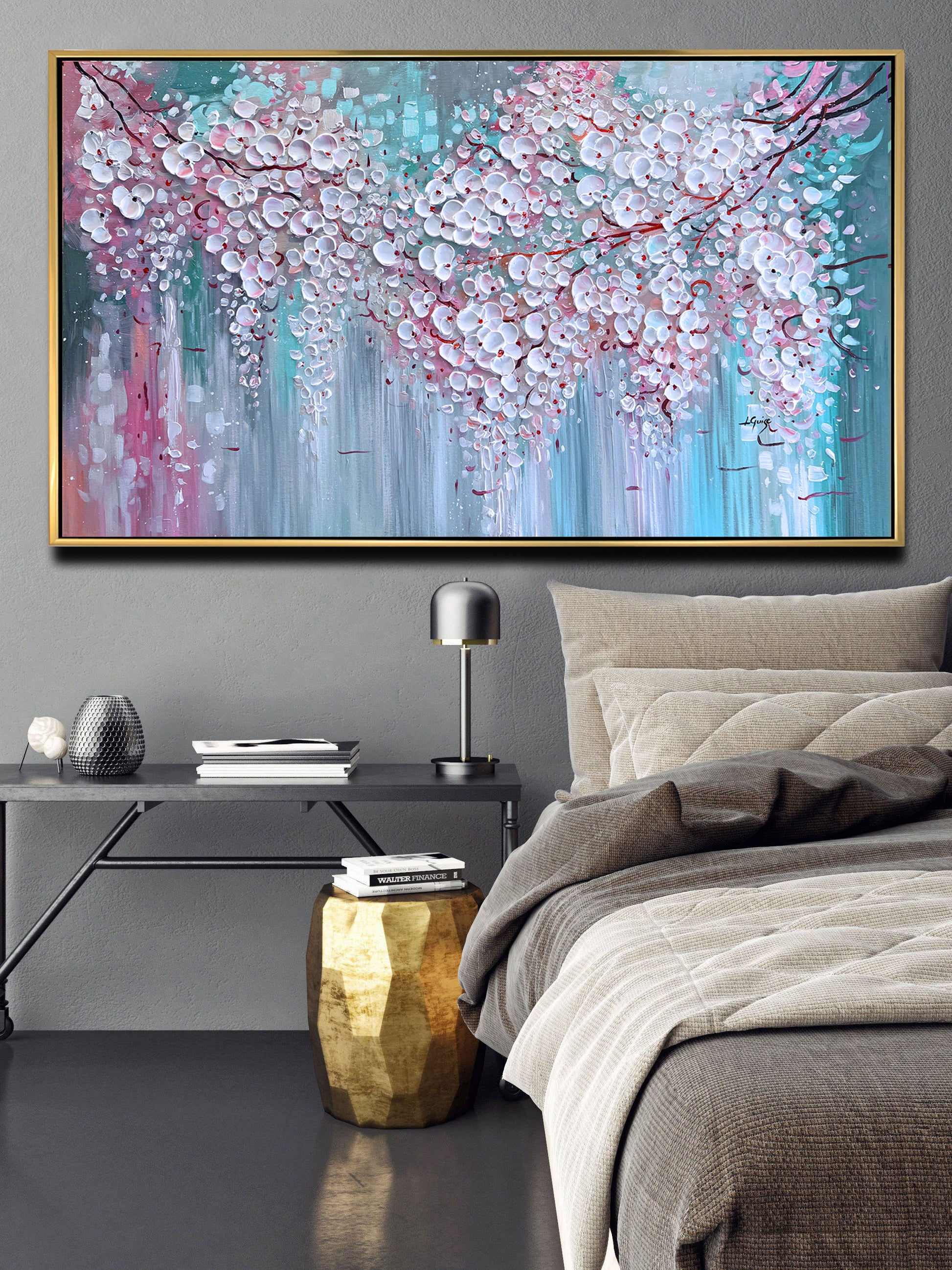 a bedroom with a bed and a painting on the wall