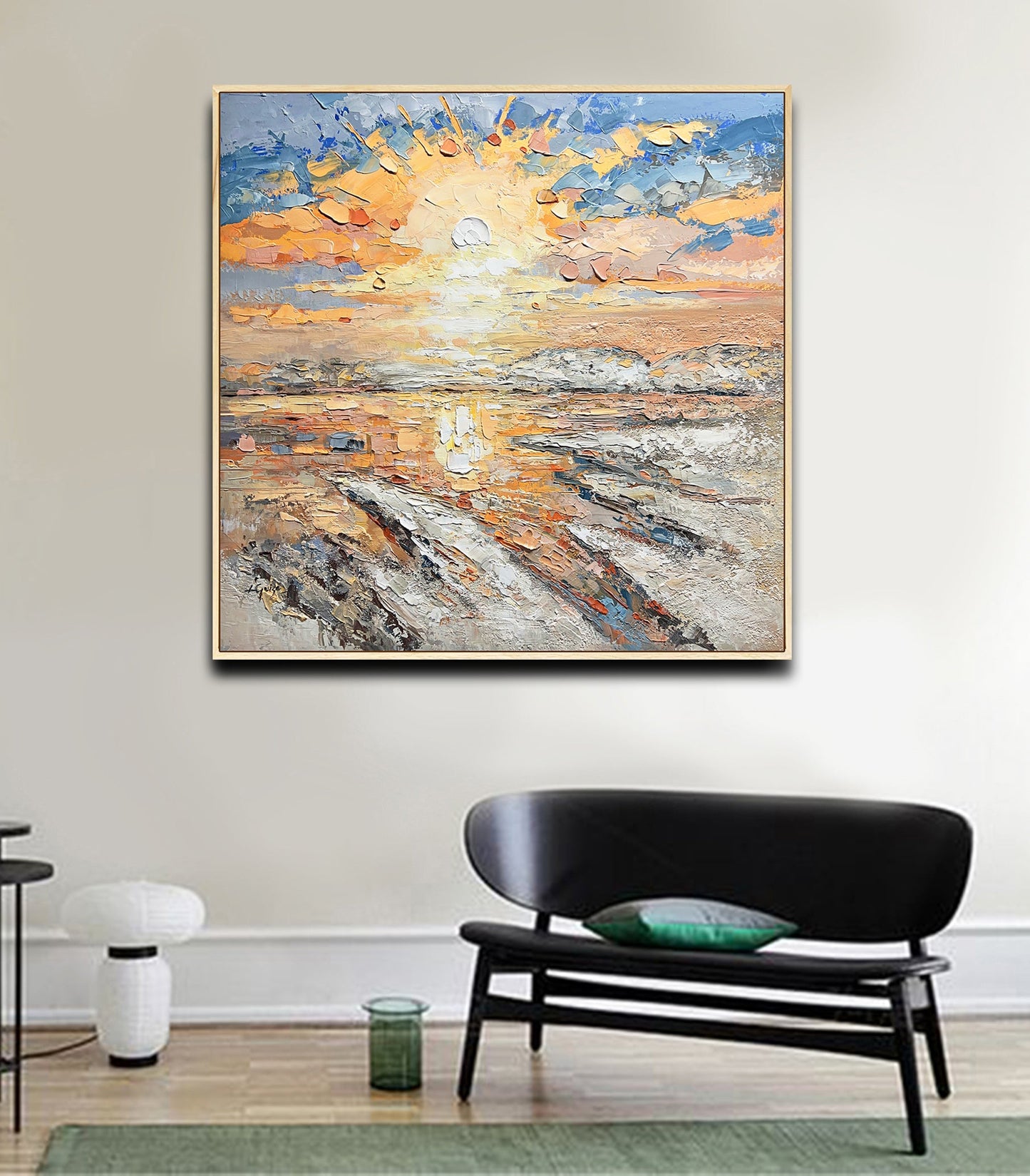 a living room with a couch and a painting on the wall