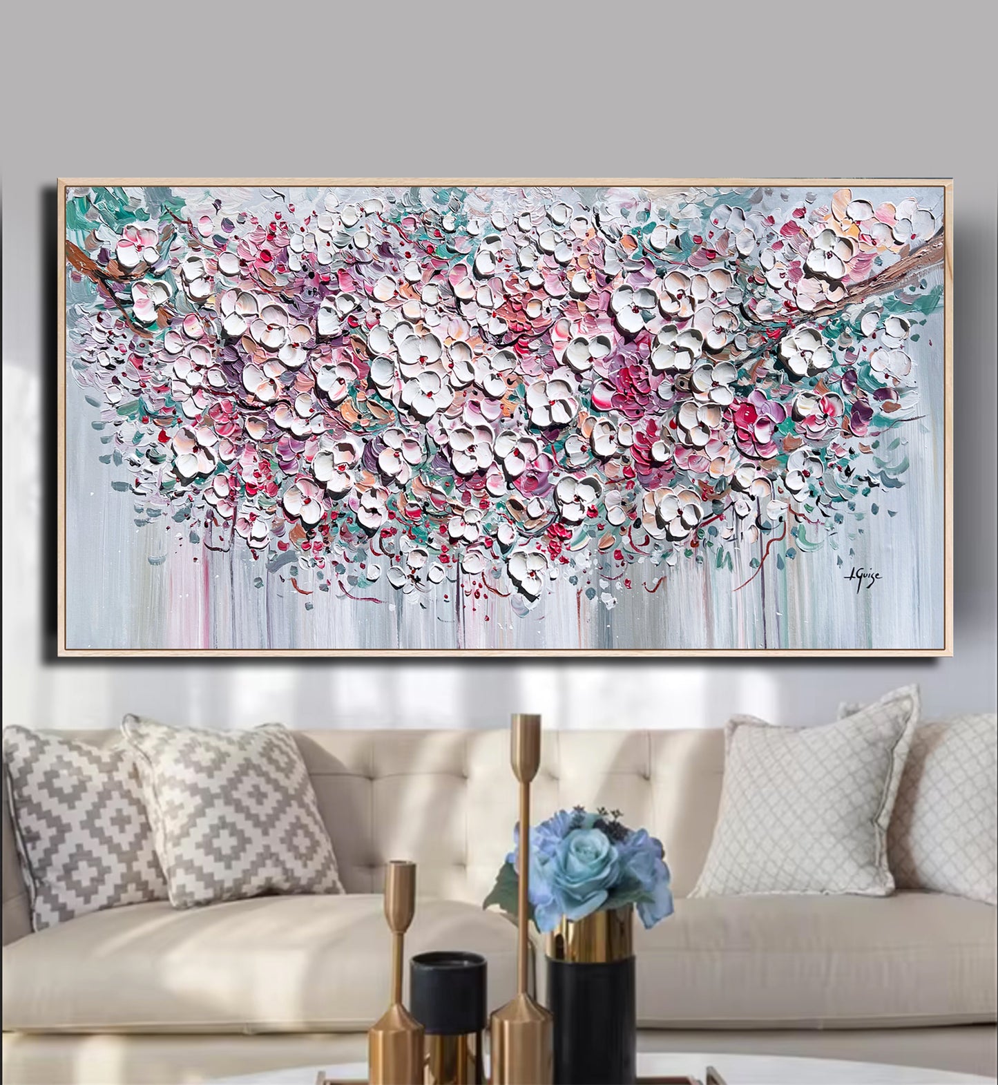 a living room with a couch and a painting on the wall