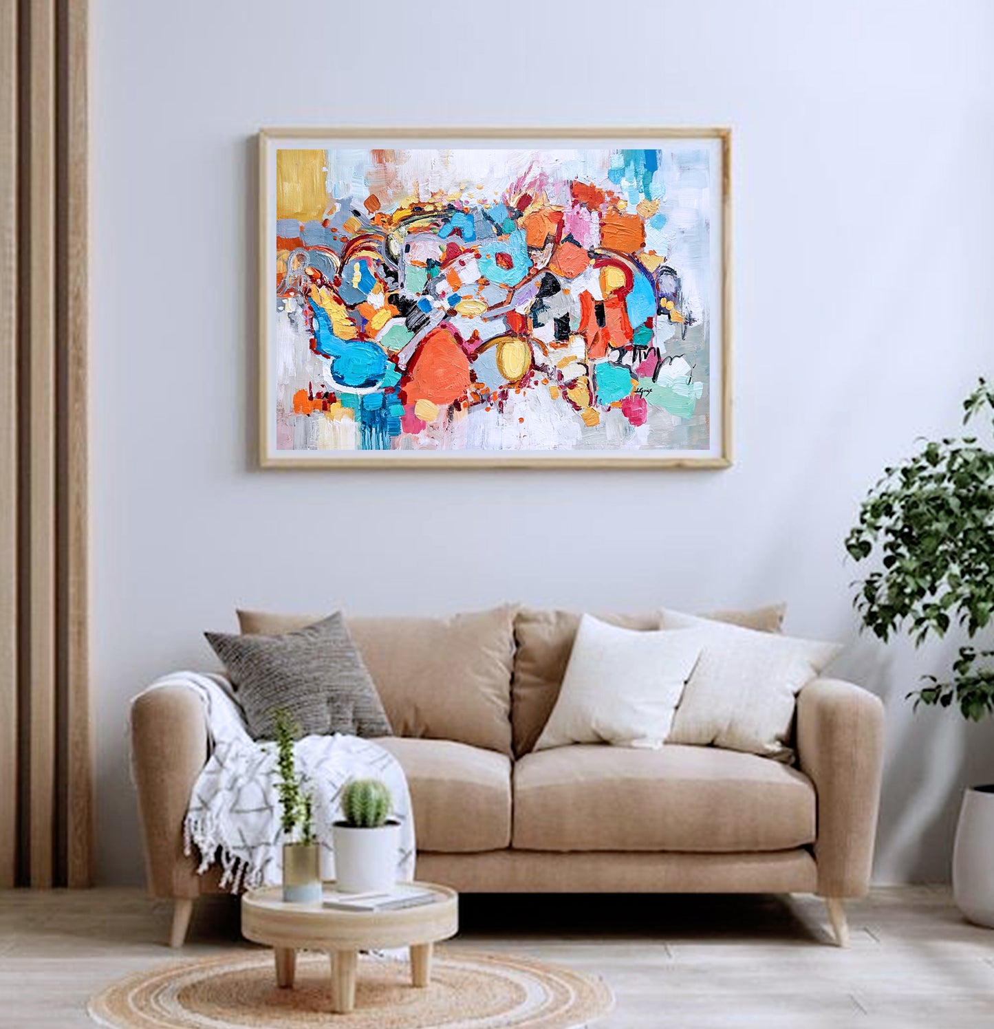 a living room with a couch and a painting on the wall