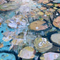 a close up of a painting of water lilies