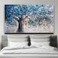 a painting of a tree on a wall above a bed