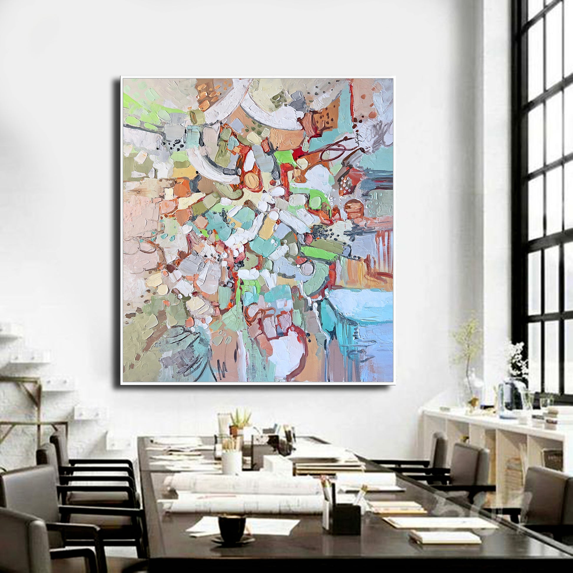 a large painting hanging on a wall above a dining room table
