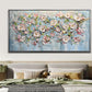 a large painting of pink flowers on a blue background