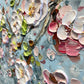 a close up of a painting with flowers on it