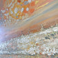a painting of a beach with a sky in the background