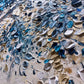a close up of a piece of art made out of broken glass