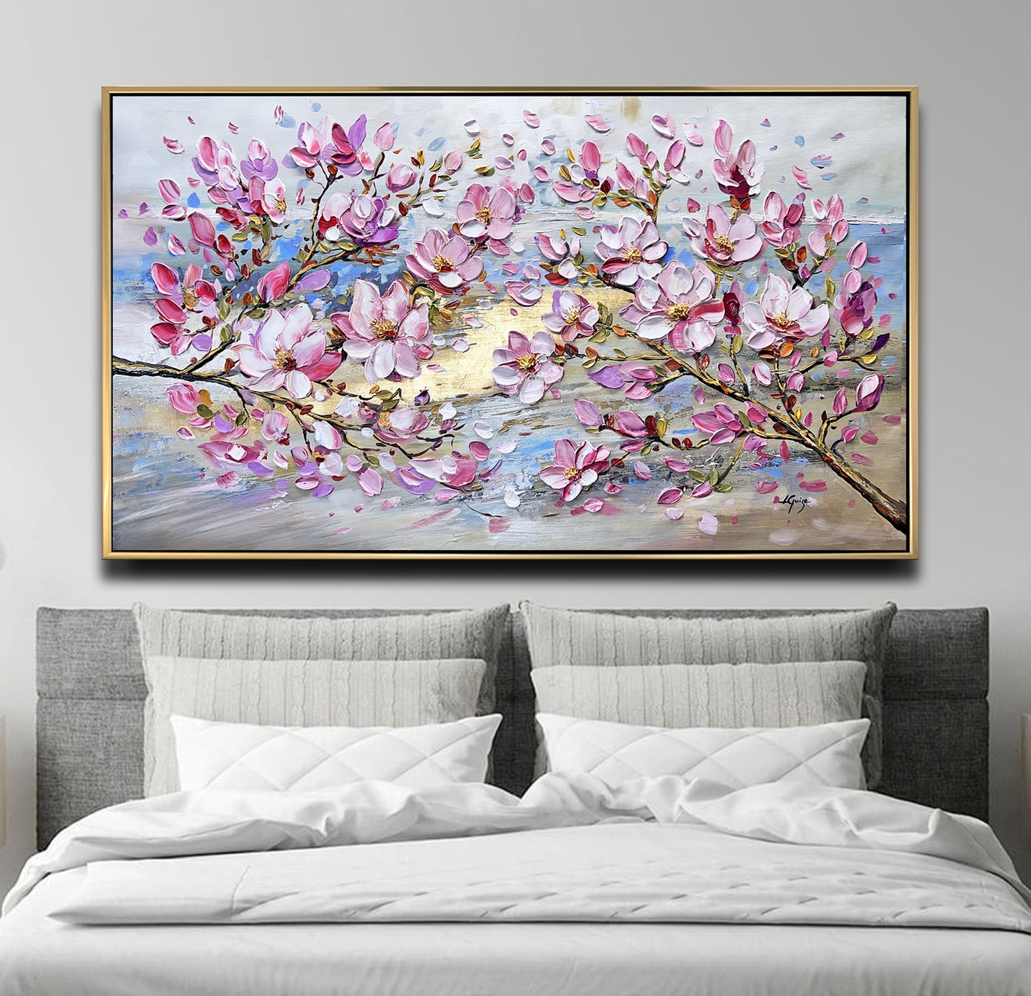 a bed with a white comforter and a painting on the wall above it