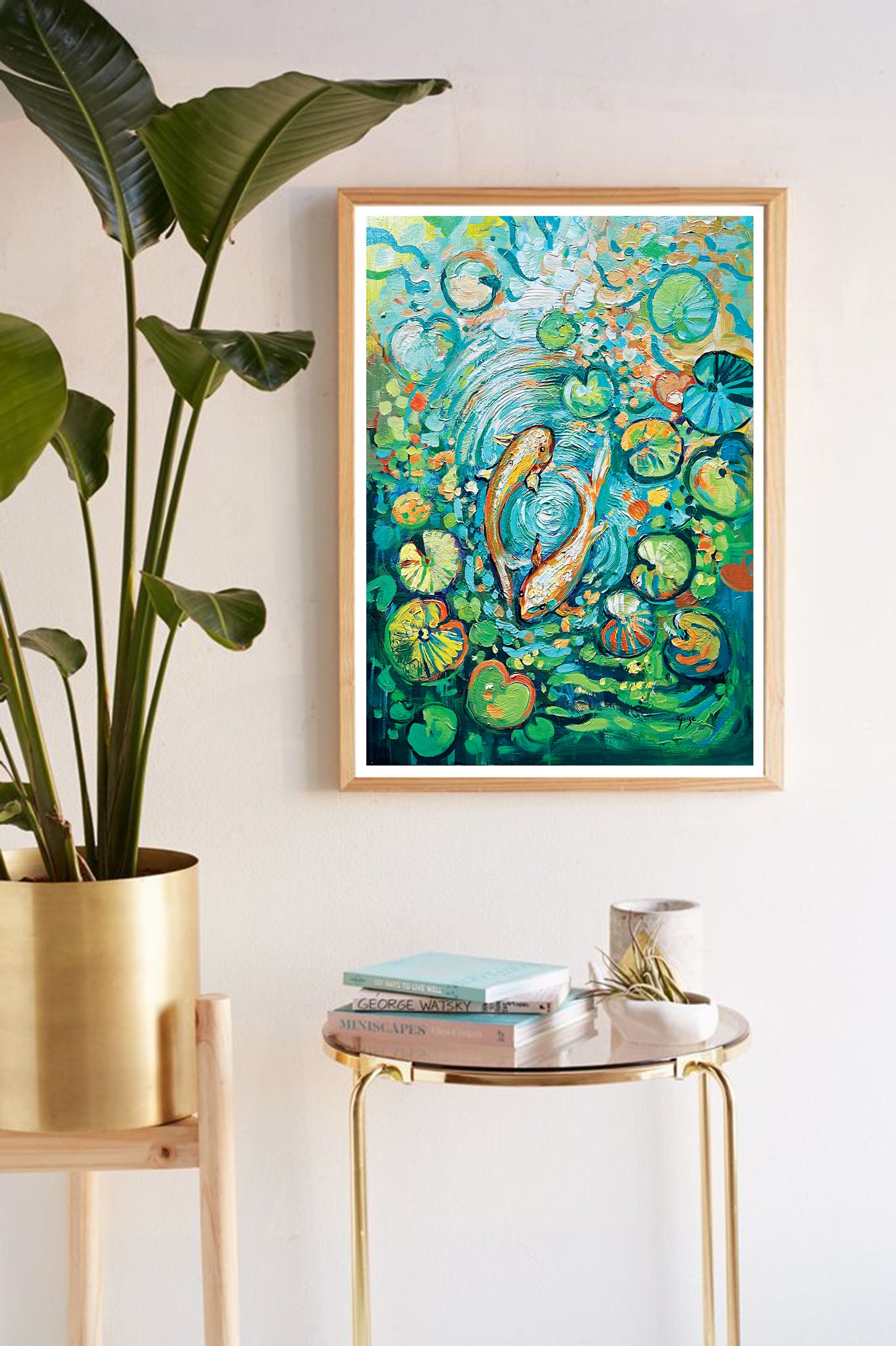 a painting hanging on a wall next to a potted plant