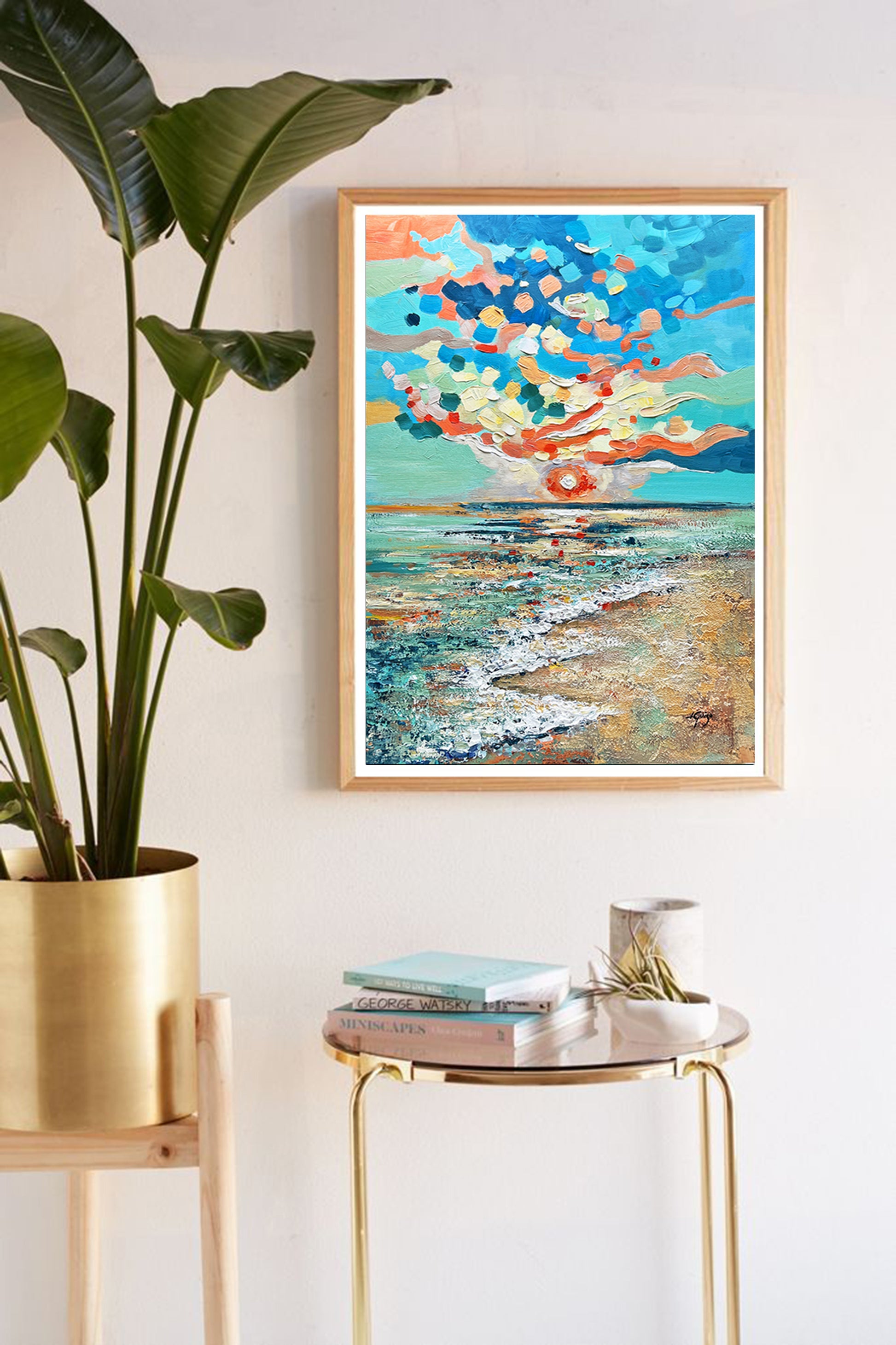 a painting hanging on a wall next to a potted plant