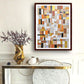 a table with a vase of flowers and a painting on the wall