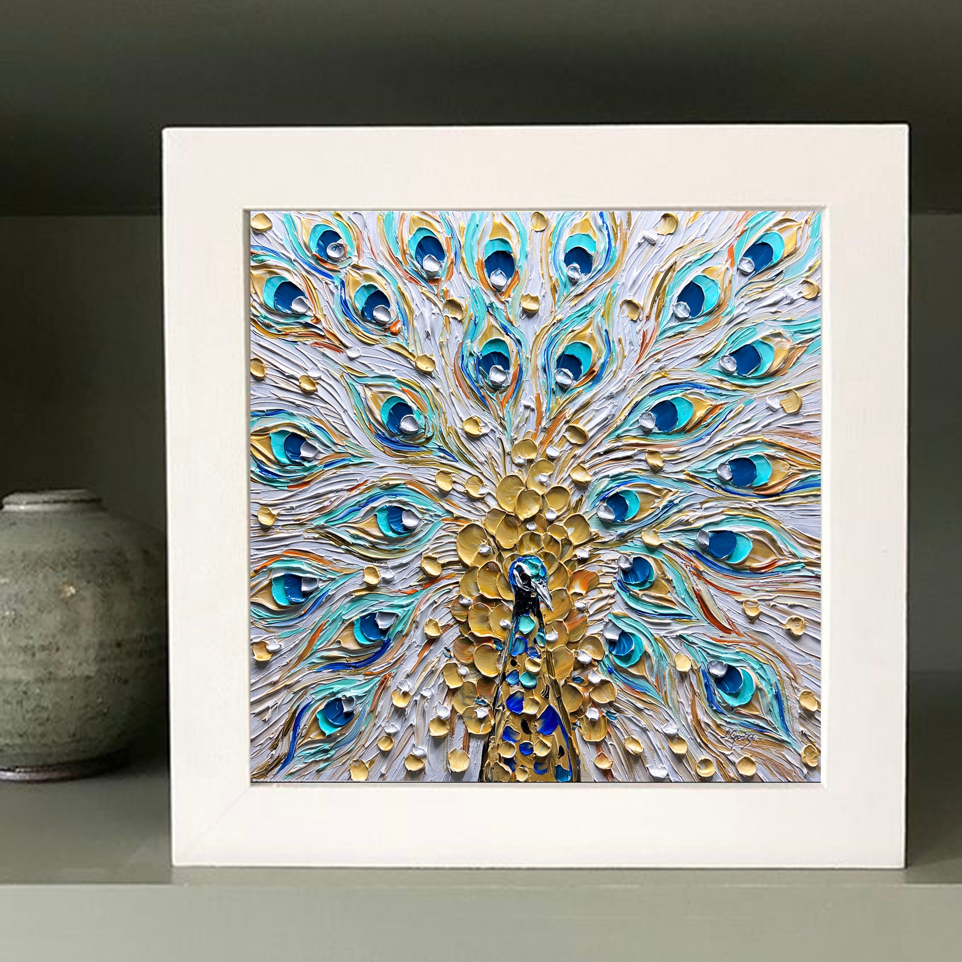 a picture of a peacock's feathers on a shelf