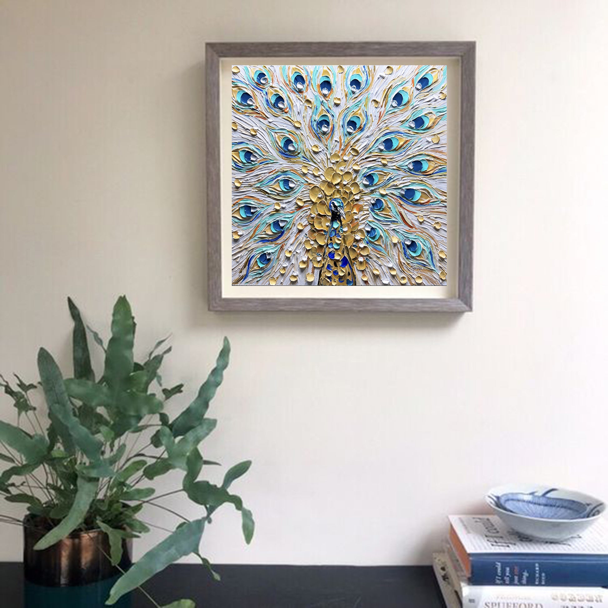 a picture of a peacock is hanging on a wall