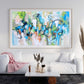 a living room with a white couch and a painting on the wall